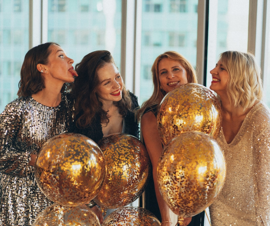 Friends celebrating New Year’s Eve at Gas Street Social with gold balloons and party outfits in Birmingham