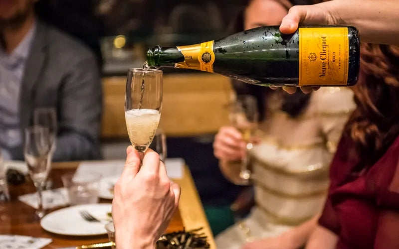 Veuve Clicquot champagne being poured into a flute at a New Year’s Eve celebration at Gas Street Social Birmingham