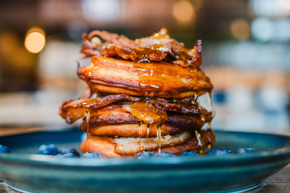 Stack of fluffy pancakes with crispy bacon and maple syrup at Gas Street Social Birmingham.