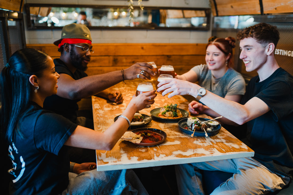 Friends sharing a meal at Gas Street Social in Birmingham, a restaurant for group dining and social celebrations.