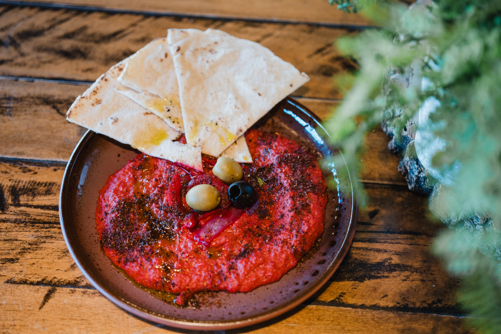 Freshly prepared beetroot hummus with olives and toasted flatbread at Gas Street Social, a Birmingham restaurant serving meze and sharing plates.