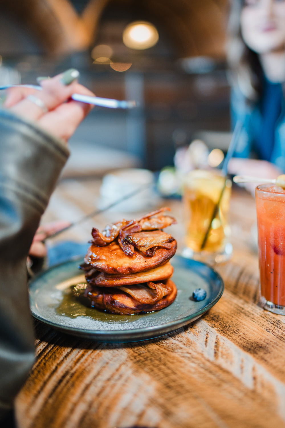Freshly prepared bacon pancakes served with drinks at Gas Street Social, a restaurant in Birmingham.