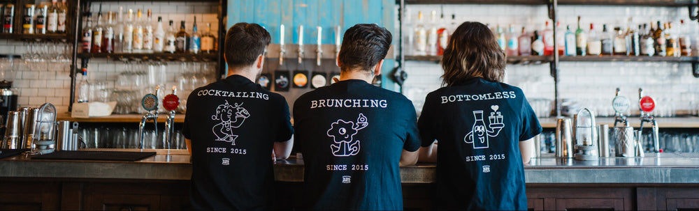 Gas Street Social bar team preparing drinks behind the bar at The Mailbox in Birmingham, celebrating cocktails, bottomless brunch and ten years of hospitality.