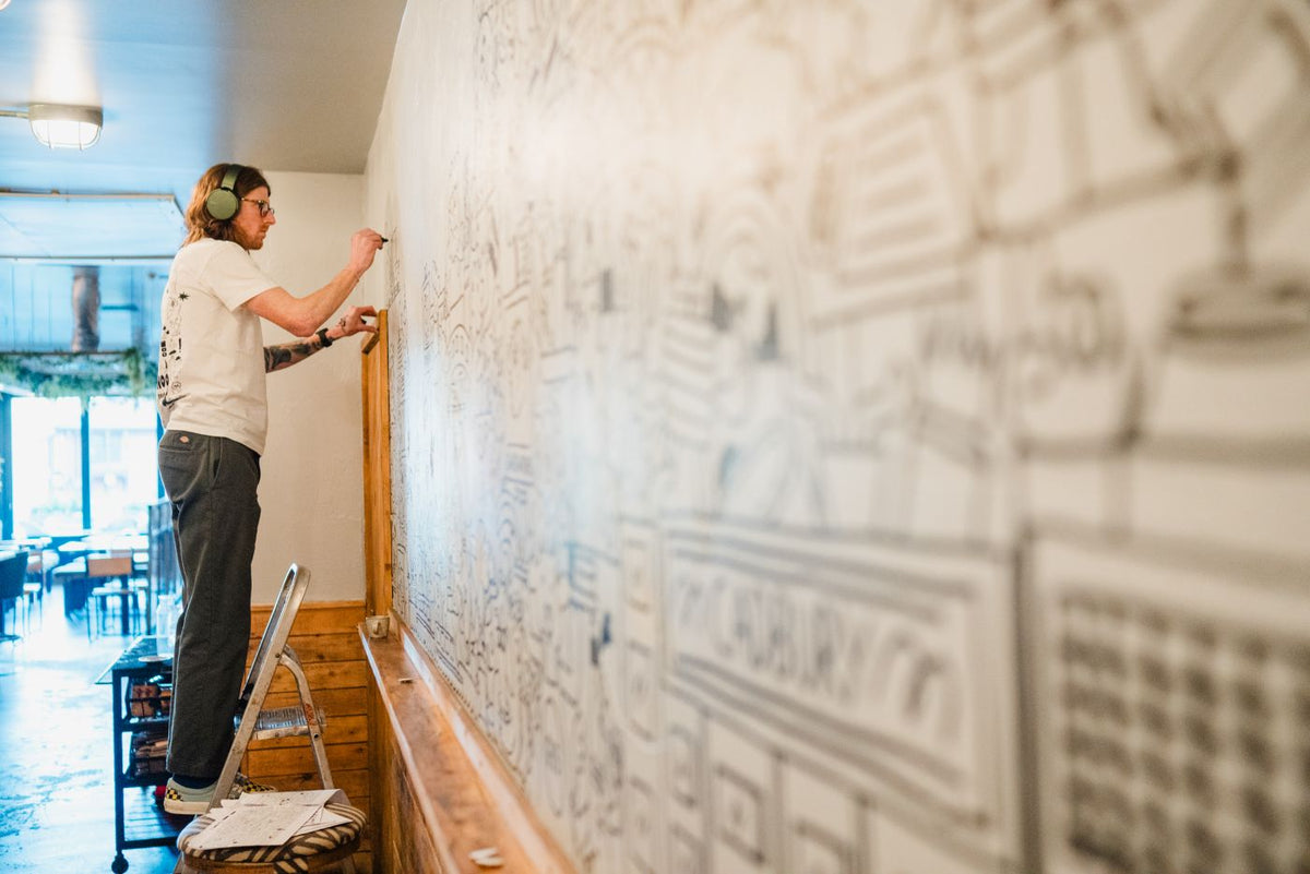 Keith Haring inspired Artist Doodling Art on wall in Gas Street Social Birmingham